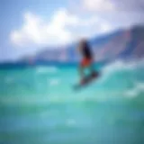 Kiteboarder gliding over turquoise waters