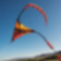 A vibrant slingshot kite soaring against a clear blue sky
