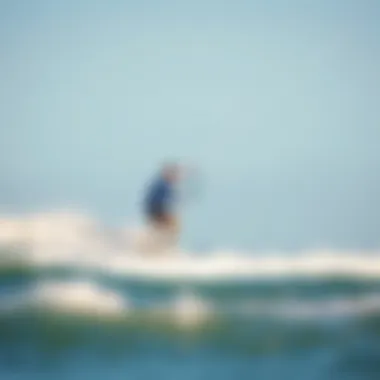 Action-Packed Kiteboarding in Jensen Beach Kiteboarder riding the waves under a clear blue sky in Jensen Beach