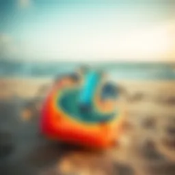 Kite surfboard with vibrant design on sandy beach