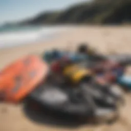 A collection of kiteboarding equipment displayed on a beach.