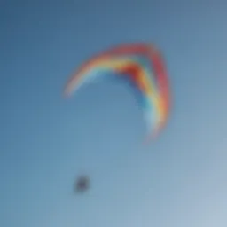 A vibrant trainer kite soaring against a clear blue sky